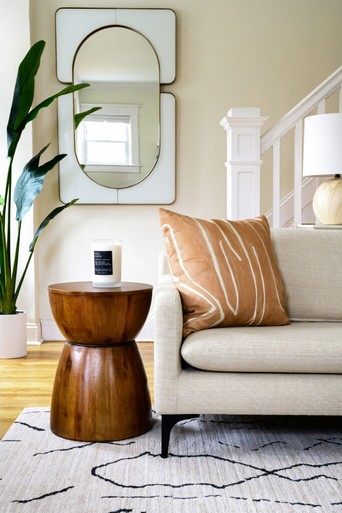 Tan couch with a unique corner table next to it